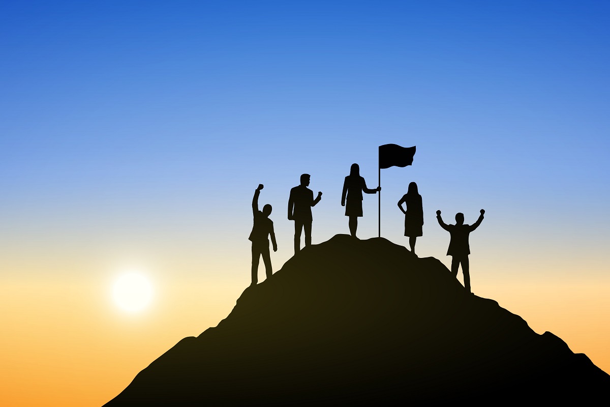 Silhouette of people on top the mountain at sunrise